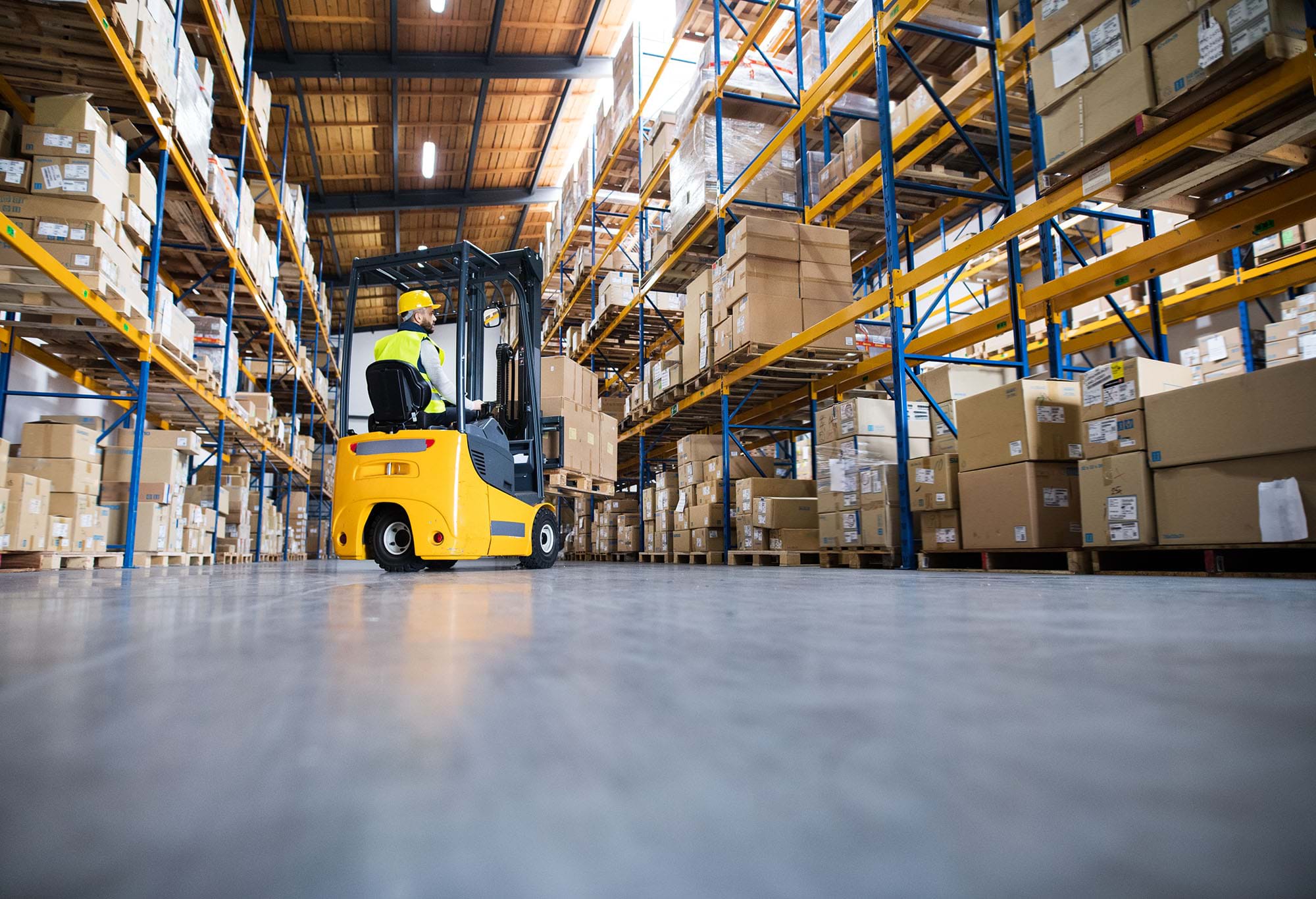 man driving a forklift truck in a warehouse